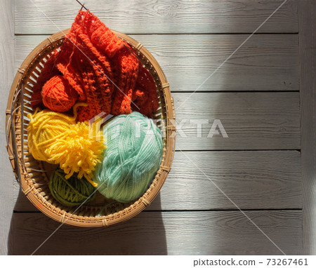 knitting yarn, needles, skeins of yarn. spring colors for knitting. knitting yarn, needles, skeins of yarn. spring colors for knitting. 73267461