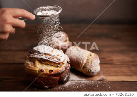 Traditional easter cake Kraffin stands on wooden table against a dark background. 73268130