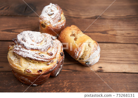 Traditional easter cake Kraffin stands on wooden table against a dark background. Traditional easter cake Kraffin stands on wooden table against a dark background. 73268131