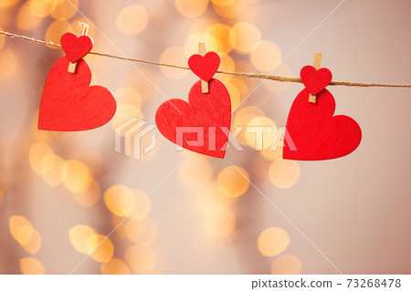 Happy Valentine day background with red hearts hang with clothespin on rope with bokeh background, romantic design, greeting card or copy space 73268478