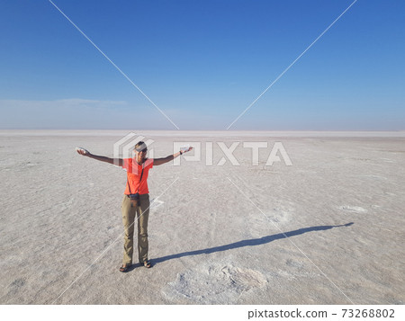 Girl on white surface of dried up Tuz ake 73268802
