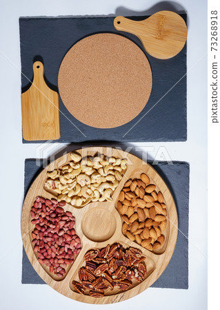 Healthy mix of nuts. Pecans, Cashews, almonds, peanuts, pine nuts, walnuts, hazelnuts. vertical photo Healthy mix of nuts. Pecans, Cashews, almonds, peanuts, pine nuts, walnuts, hazelnuts. vertical photo 73268918