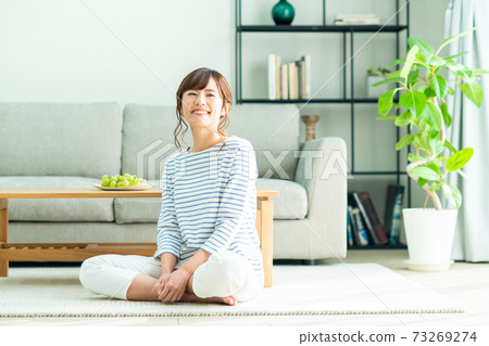 Young woman relaxing in the living room Young woman relaxing in the living room 73269274