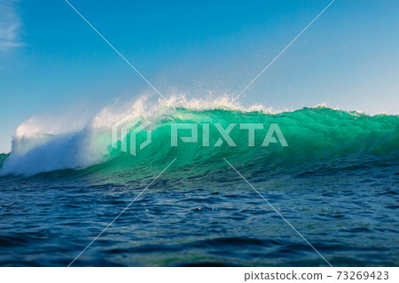 Surfing wave in ocean. Breaking turquoise wave sunny day Surfing wave in ocean. Breaking turquoise wave sunny day 73269423