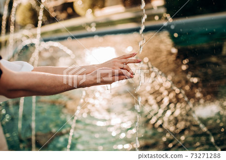 hands lovers splashing fountain playing water summer 73271288