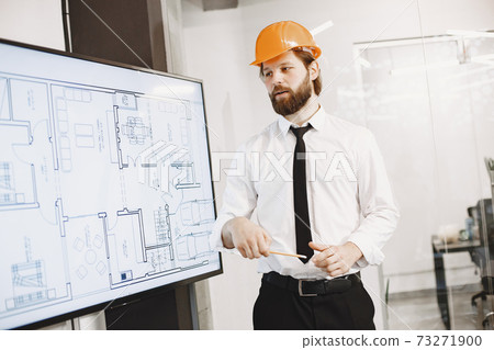 Young manager in the office with helmet Young manager in the office with helmet 73271900