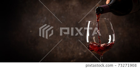 Pouring red wine into the glass Pouring red wine into the glass 73271908