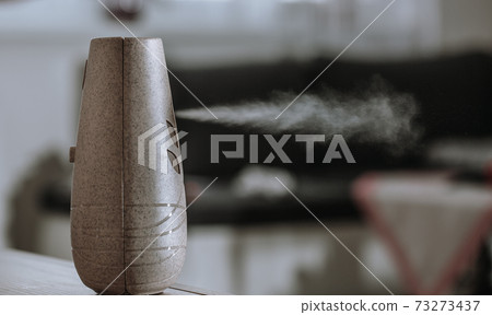 Close up of spraying an air freshener or diffuser scent at home Close up of spraying an air freshener or diffuser scent at home 73273437