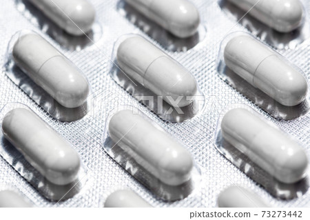 Close up of capsules pills in a blister pack, pharmaceutical and pharmacy concept, macro image Close up of capsules pills in a blister pack, pharmaceutical and pharmacy concept, macro image 73273442