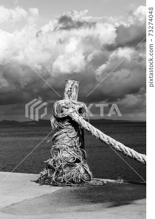 Rope on seafront, sea and beautiful cloudy sky in sunny summer day 73274048