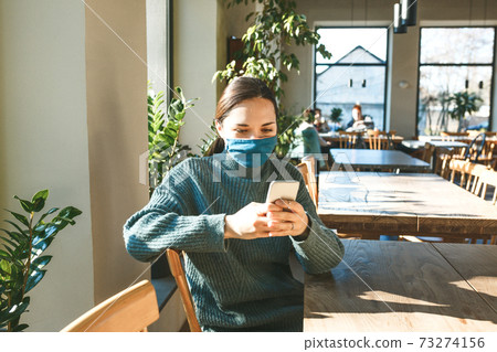 A girl uses a cell phone A girl uses a cell phone 73274156