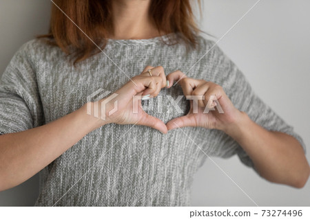 Close up of woman show love hand gesture 73274496