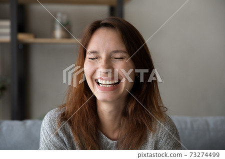 Close up of happy young woman laugh at home Close up of happy young woman laugh at home 73274499