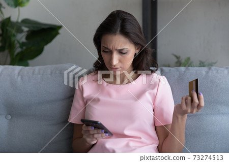 Unhappy woman frustrated by error paying online on cell 73274513