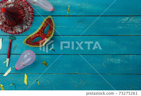 Table top view aerial image of beautiful colorful carnival festival background.Flat lay accessory object the several mask decor confetti on modern blue wooden at home office desk studio.copy space. Table top view aerial image of beautiful colorful carnival festival background.Flat lay accessory object the several mask decor confetti on modern blue wooden at home office desk studio.copy space. 73275261