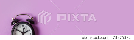 Simply minimal design ringing twin bell vintage classic alarm clock Isolated on purple background. Rest hours time of life good morning night wake up awake concept Flat lay top view copy space banner 73275382