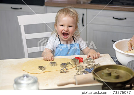 Laughing little boy prepare for baking cookies at home Laughing little boy prepare for baking cookies at home 73276077