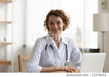 Portrait of smiling attractive trusted young female general practitioner. Portrait of smiling attractive trusted young female general practitioner. 73276432
