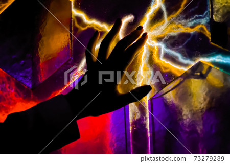 Woman hand touching plasma panel display in dark room of museum - close up view 73279289