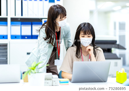 A woman who wears a mask and works 73280895