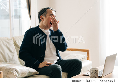 Image of a man who feels tired of working from home Image of a man who feels tired of working from home 73286351