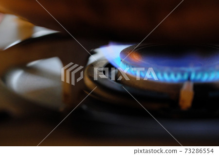 Blue fire on the stove under the pot 73286554