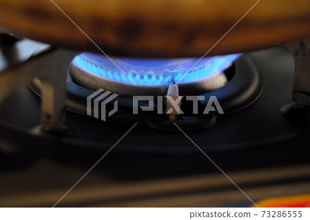 Blue fire on the gas stove seen from an angle 73286555