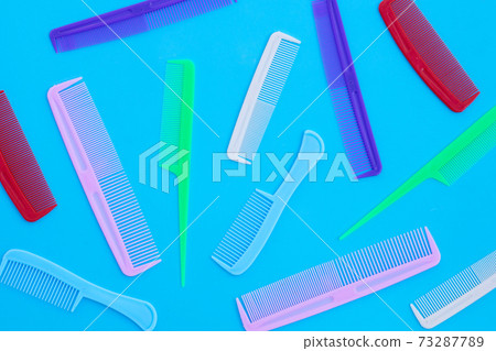 Combs on blue background. Top view Combs on blue background. Top view 73287789