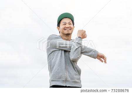 A man stretching with a smile 73288676