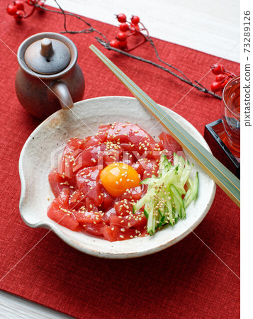 Yukhoe of lean bluefin tuna. Tuna cut into strips, entwined with soy sauce, gochujang + sake + sesame oil sauce. 73289126