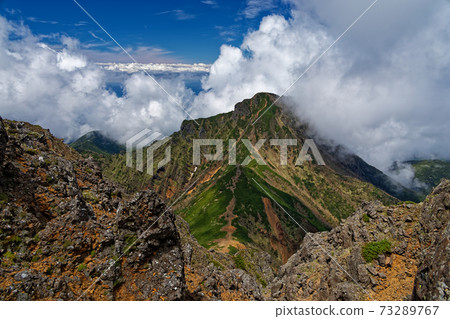 Cloudy Amidake seen from Yatsugatake Mountain Range, Akadake Cloudy Amidake seen from Yatsugatake Mountain Range, Akadake 73289767
