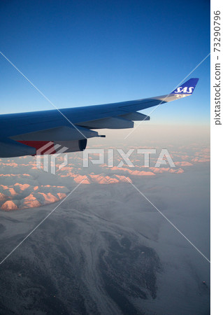 SAN FRANCISCO, CALIFORNIA, UNITED STATES - NOV 24th, 2018: Greenland view from airplane, frozen mountains or glaciers with wing view SAN FRANCISCO, CALIFORNIA, UNITED STATES - NOV 24th, 2018: Greenland view from airplane, frozen mountains or glaciers with wing view 73290796