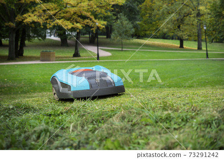 Autonomous lawnmower in a park  73291242