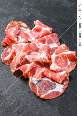 Coppa, Capocollo, Capicollo meat. Black background. Top view 73291879