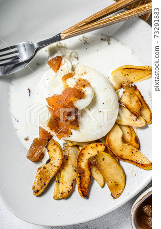 Burrata Buffalo cheese with pear. Gray background. Top view Burrata Buffalo cheese with pear. Gray background. Top view 73291883
