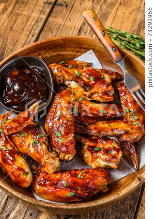 Grilled chicken wings with bbq sauce. wooden background. Top view 73291966