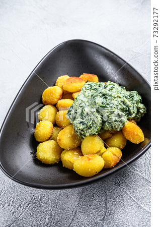 Homemade Potato Gnocchi fried in a pan. White background. Top view 73292177