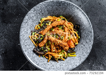Udon noodles with chicken and peppers. Black background. Top view 73292194