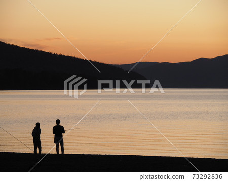 People fishing at Lake Shikotsu, which is dyed in the sunset People fishing at Lake Shikotsu, which is dyed in the sunset 73292836