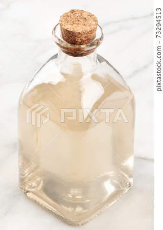 A corked bottle of a homemade face tonic 73294513
