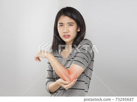 young asian woman feel elbow bones injury 73295687