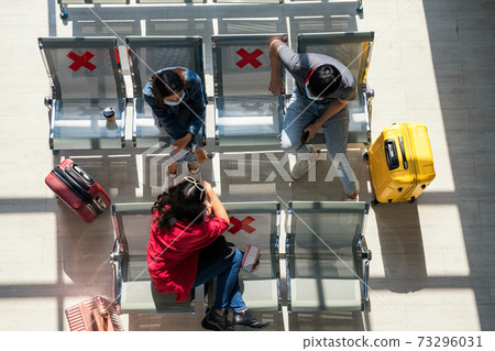 Friends talk at airport terminal seat. Wait to depart 73296031