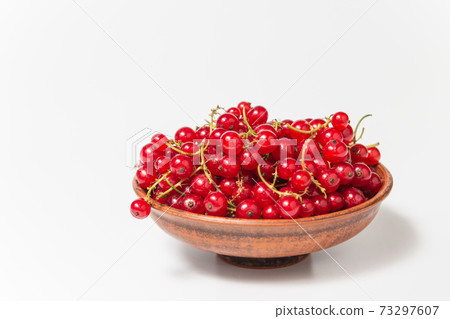 Red currant in clay bowl on white background. Fruit bowl. Delicious food. Copy space. High quality close up photo Red currant in clay bowl on white background. Fruit bowl. Delicious food. Copy space. High quality close up photo 73297607