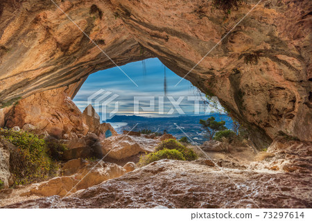 Long exposure of Benidorm city from inside the cave 73297614