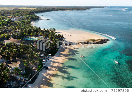 View from the height of the east coast of the island of Mauritius. Flying over the turquoise lagoon of the island of Mauritius in the area of Bel Mare. View from the height of the east coast of the island of Mauritius. Flying over the turquoise lagoon of the island of Mauritius in the area of Bel Mare. 73297896