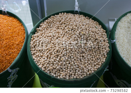 red lentils, peas, chick peas in green eco bags, close up red lentils, peas, chick peas in green eco bags, close up 73298582