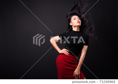 Young beautiful Asian transgender businesswoman against black background Young beautiful Asian transgender businesswoman against black background 73298968