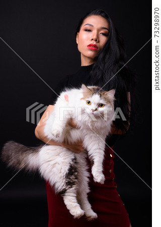 Young beautiful Asian transgender businesswoman against black background Young beautiful Asian transgender businesswoman against black background 73298970