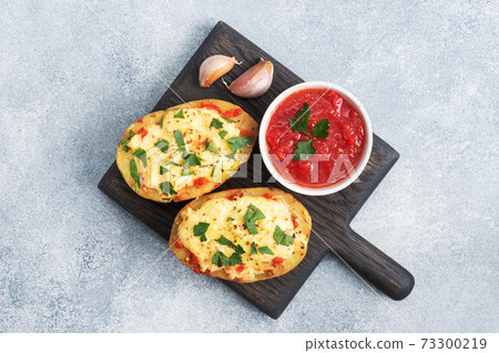 Baked potatoes in the peel stuffed with cheese with garlic and herbs. Copy space Baked potatoes in the peel stuffed with cheese with garlic and herbs. Copy space 73300219