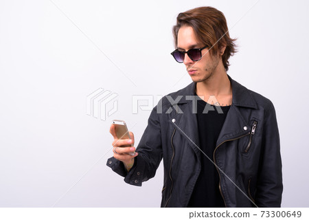 Young handsome rebellious man against white background 73300649
